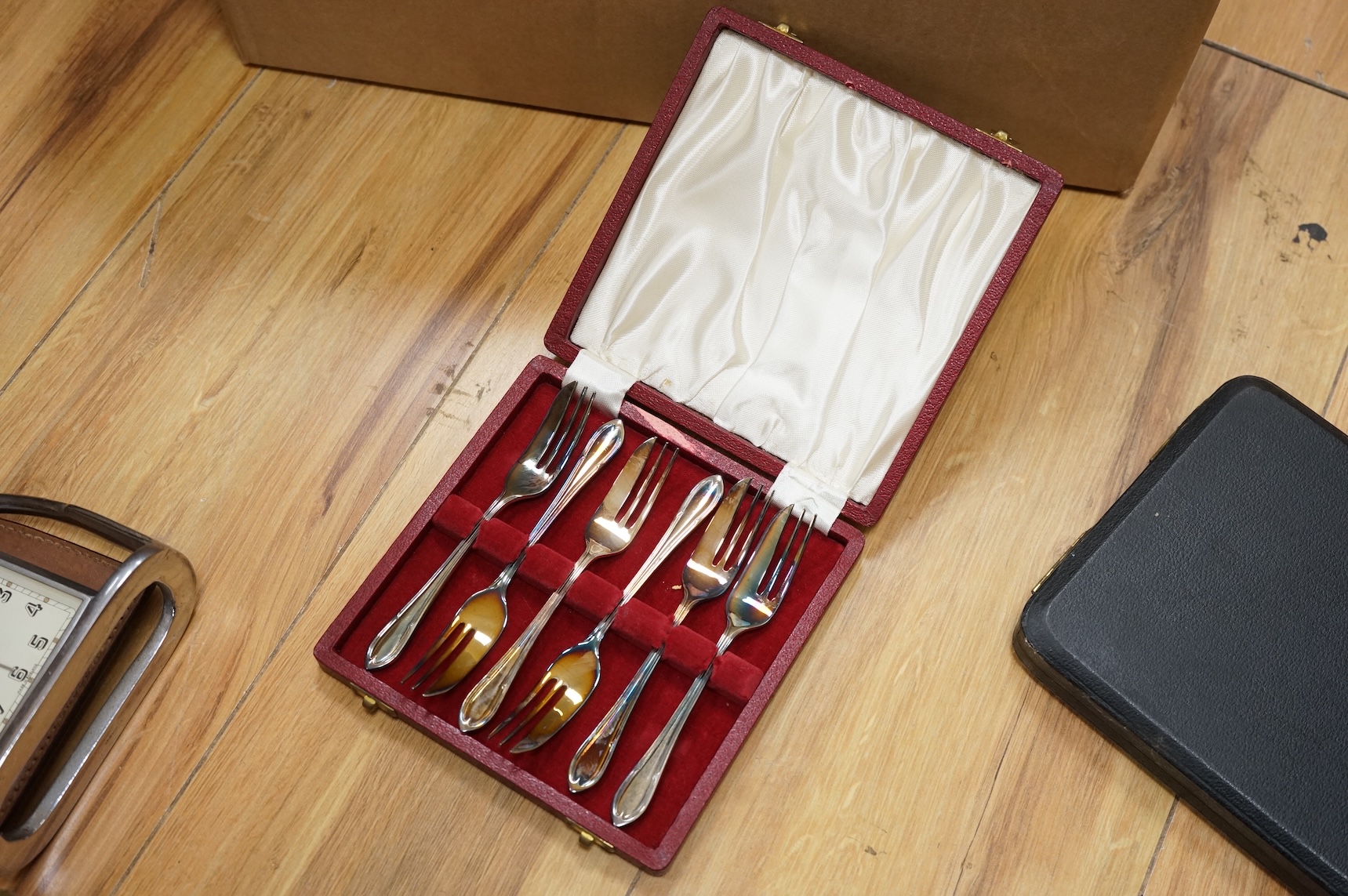 A group of assorted plated items including entree dishes, flatware and wine coaster.